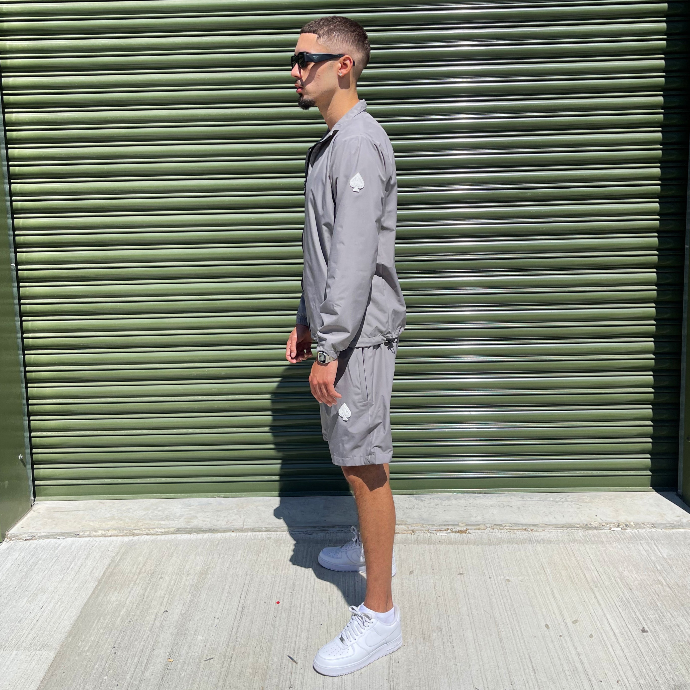Modern men's grey streetwear tracksuit by Gabos London, complete with zip-up jacket and cargo-style shorts for effortless warm-weather looks