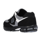 Black and gray sneaker with a brand logo on a white background