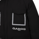 Close-up of a black puffer jacket featuring a front flap pocket with reflective silver trim and the 'GABOS LONDON' logo printed in white below.