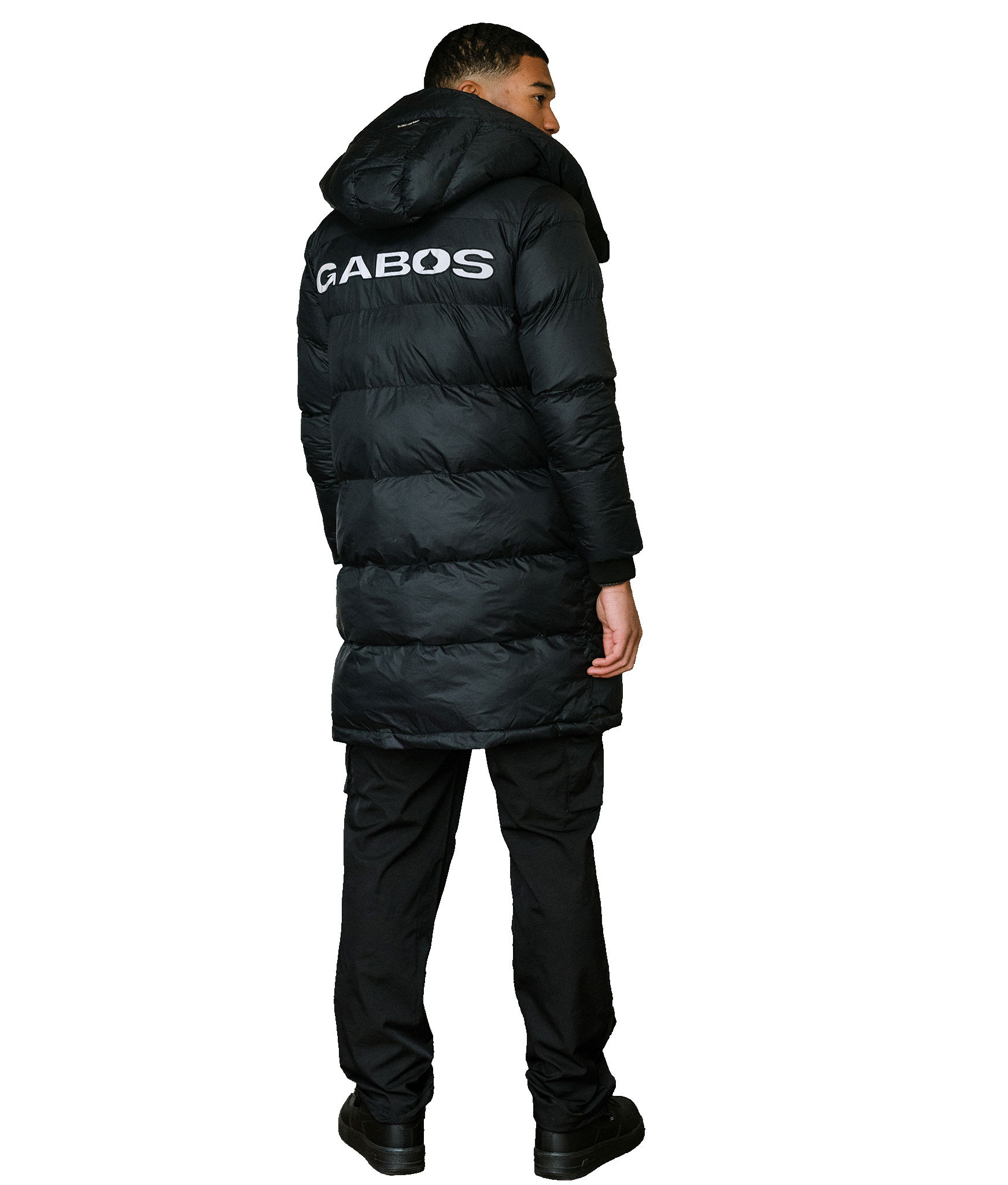 A man wearing a long black puffer jacket with 'GABOS' printed in white on the back, shown from a rear three-quarter view against a plain white background.