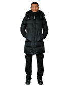A man modeling a long black puffer coat with a high collar, front zipper, and a visible 'CLIMBER' logo patch on the left chest, paired with black pants and black shoes against a plain white background.
